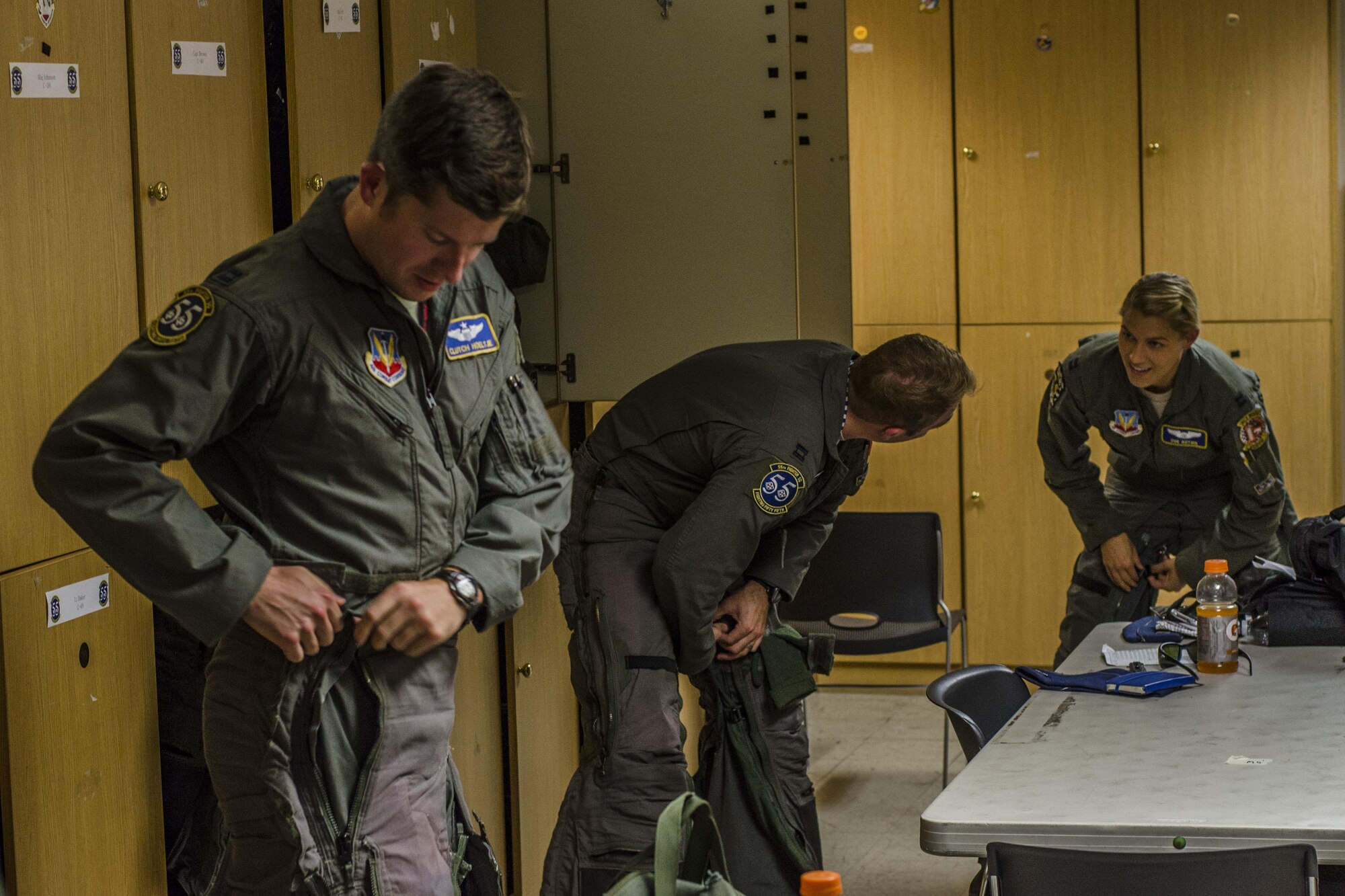 U.S. Air Force pilots from the 55th Fighter Squadron, Shaw Air Force Base, S.C., attach their g‐suites in preparation for a familiarization flight at Nellis Air Force Base, Nev., Aug. 13, 2016. The g‐suite is used to squeeze blood from the legs into the head while at high speeds enabling the pilots to fly longer hours. (U. S. Air Force photo by Tech. Sgt. Frank Miller/Released)