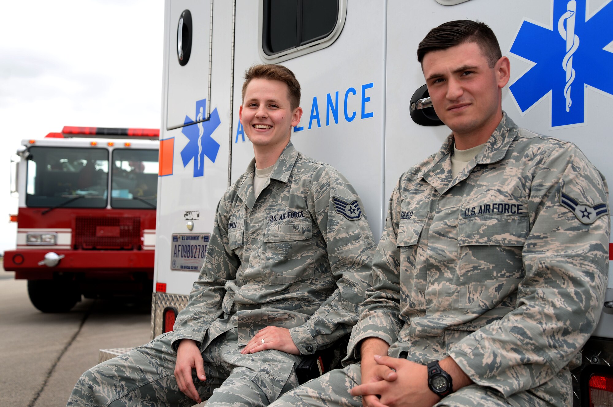 U.S. Air Force Staff Sgt. Jonathon Powell, left, and U.S. Air Force Airman 1st Class Andrew Giles, both 48th Medical Operations Squadron emergency services technicians, pose for a photograph after an exercise emergency response scenario Aug. 11, 2016, on RAF Mildenhall, England. The medics from RAF Lakenheath are assigned to the 100th Civil Engineering Squadron, which significantly cuts down emergency response time and creates a more dynamic training environment for both firefighters and medics. (U.S. Air Force photo by Senior Airman Justine Rho)