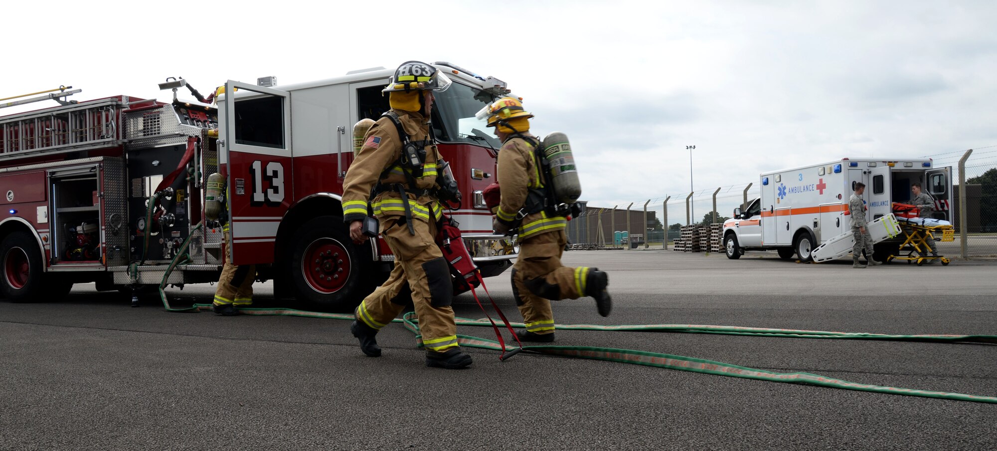 Firefighters assigned to the 100th Civil Engineer Squadron hustle to assess an exercise scenario Aug. 11, 2016, on RAF Mildenhall, England. Medics assigned to RAF Mildenhall, from the 48th Medical Operations Squadron on RAF Lakenheath, prepare their equipment in anticipation of patients. (U.S. Air Force photo by Senior Airman Justine Rho)