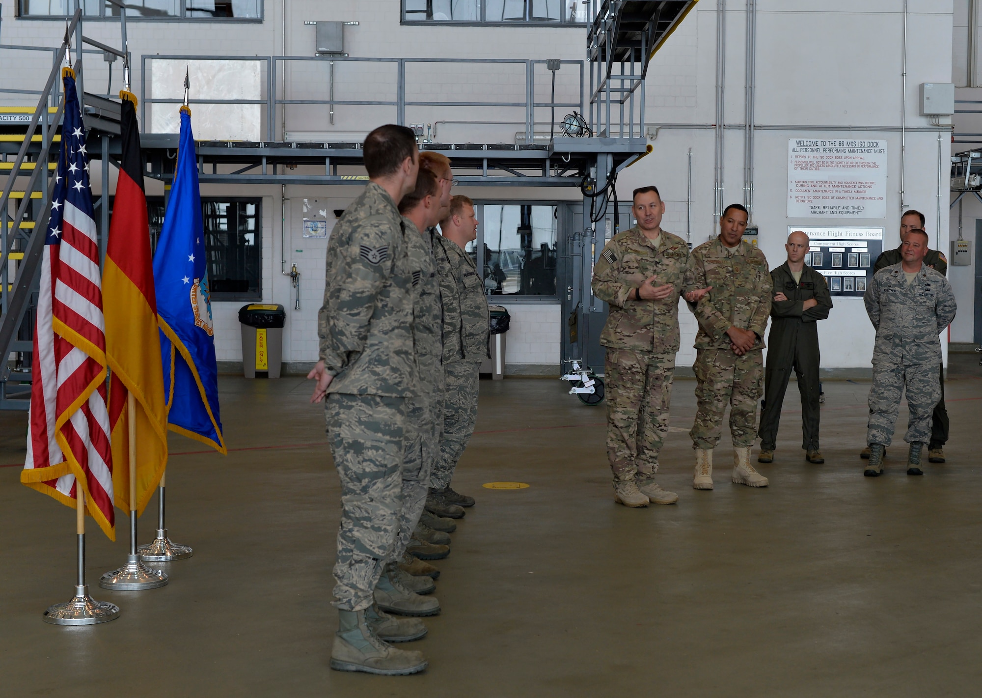 Col. Robert Orris, Joint Special Operations Air Component commander-Africa, middle, talks during a coin ceremony Aug. 10, 2016, Ramstein, Germany. Five Ramstein Airmen were coined for successful completion of an aircraft recovery mission. (U.S. Air Force photo/Senior Airman Nesha Humes)