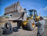 Col. Steven Zubowicz, 52nd Mission Support Group commander, works to pick up a tire using a front-end loader bucket at Spangdahlem Air Base, Germany, Aug. 11, 2016. (U.S. Air Force photo by Tech. Sgt. Christopher Parr)                                                                                                                     