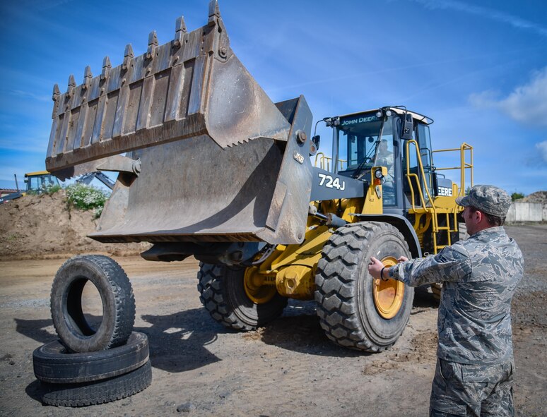 Col. Steven Zubowicz, 52nd Mission Support Group commander, works to pick up a tire using a front-end loader bucket at Spangdahlem Air Base, Germany, Aug. 11, 2016. (U.S. Air Force photo by Tech. Sgt. Christopher Parr)                                                                                                                     