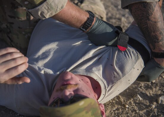 Senior Airman Austin Henson, 83rd Expeditionary Rescue Squadron pararescue specialist, places a tourniquet on a simulated patient during a mass casualty exercise, Bagram Airfield, Afghanistan, Aug. 16, 2016. Volunteers acted as wounded patients, with injuries that included broken limbs, loss of eye sight and deliria. (U.S. Air Force photo by Senior Airman Justyn M. Freeman)
