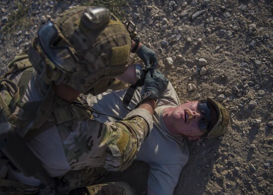 Senior Airman Austin Henson, 83rd Expeditionary Rescue Squadron pararescue specialist, places a tourniquet on a simulated wounded patient during a mass casualty exercise, Bagram Airfield, Afghanistan, Aug. 16, 2016. Volunteers acted as wounded patients, with injuries that included broken limbs, loss of eye sight and deliria. (U.S. Air Force photo by Senior Airman Justyn M. Freeman)