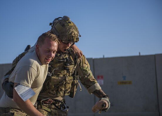 Senior Airman Austin Henson, 83rd Expeditionary Rescue Squadron pararescue specialist, helps a simulated wounded patient walk during a mass casualty exercise, Bagram Airfield, Afghanistan, Aug. 16, 2016. The 83rd ERQS provides the only U.S. personnel recovery assets in Afghanistan. In order to maintain readiness and skill level, they participate in real world scenario exercises. (U.S. Air Force photo by Senior Airman Justyn M. Freeman)