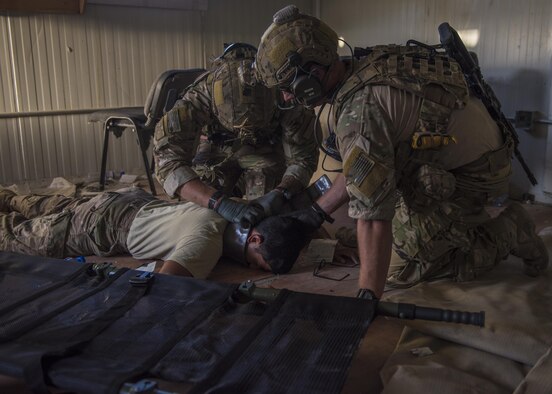 Senior Airman Kyle Green and Senior Airman Austin Henson, 83rd Expeditionary Rescue Squadron pararescue specialists, place a cervical collar on a simulated patient, Bagram Airfield, Afghanistan, Aug. 16, 2016. Also known as a neck brace, a cervical collar is used on patients who have traumatic head or neck injuries. (U.S. Air Force photo by Senior Airman Justyn M. Freeman)