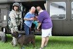 Soldiers of the Louisiana National Guard offload citizens and pets displaced by rising floodwaters in Baton Rouge and the surrounding area at Celtic Studios in Baton Rouge, La., Aug. 14, 2016.