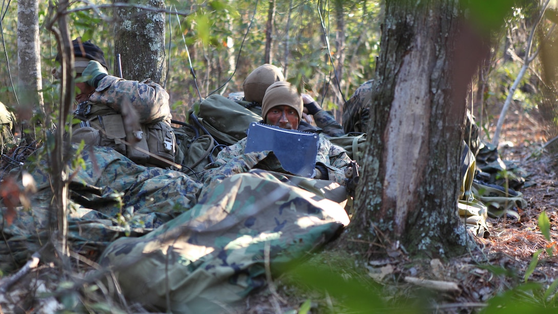 Marines with the 22nd Marine Expeditionary Unit radio reconnaissance team collect communications signals in the field during an Intelligence Interoperability Course, Dec. 15, 2010. The Radio Reconnaissance team was embedded in the dense forest covered with camouflage paint, and equipped with a small arsenal of weapons and intelligence exploitation equipment.