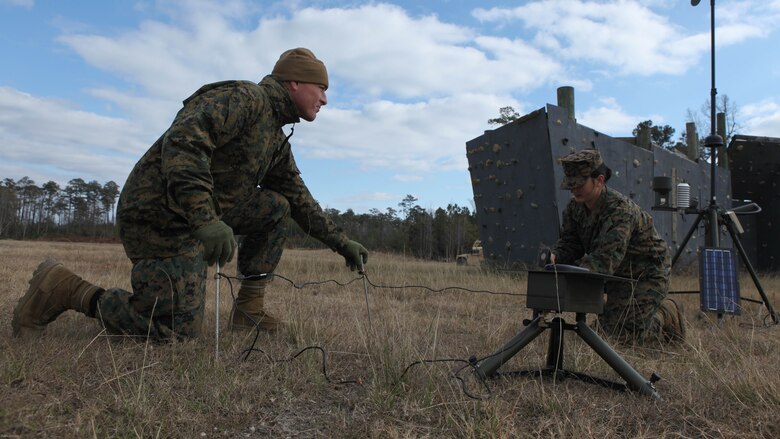 Staff Sgt. Dustin G. Heflin, a native of Dodge City, Kan., and Cpl. Alleia D. Arthur, a Salem, Ore., native, both forecasters with the 22nd Marine Expeditionary Unit meteorological and oceanographic team, assemble the Automated Weather Observing System in the field during an Intelligence Interoperability Course, Dec. 13, 2010.