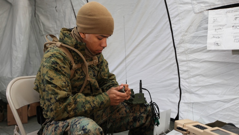 Pfc. Ariel A. Tolentino, a radio operator with the 22nd Marine Expeditionary Unit ground sensor platoon prepares ground sensors used to monitor movement, sounds and vibrations in the field during an Intelligence Interoperability Course, Dec. 15, 2010.