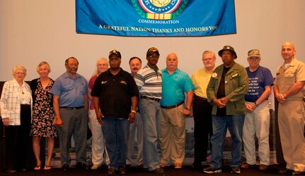 Naval Surface Warfare Center Dahlgren Division (NSWCDD) Commanding Officer CAPT Brian Durant pauses with ten Vietnam War Veterans after personally honoring them with commemorative pins and certificates during a ceremony at the command's Vietnam Commemoration held at the University of Mary Washington, Aug. 11. The event's keynote speaker, Brig. Gen. Wilma Vaught, USAF retired, (left) recounted the women in service - as well as her own service - during the Vietnam era and the challenges they faced. She was the first woman to deploy with an Air Force bomber unit, the first Air Force woman graduate of the Industrial College of the Armed Forces, and one of the most-decorated military women in U.S. history.   