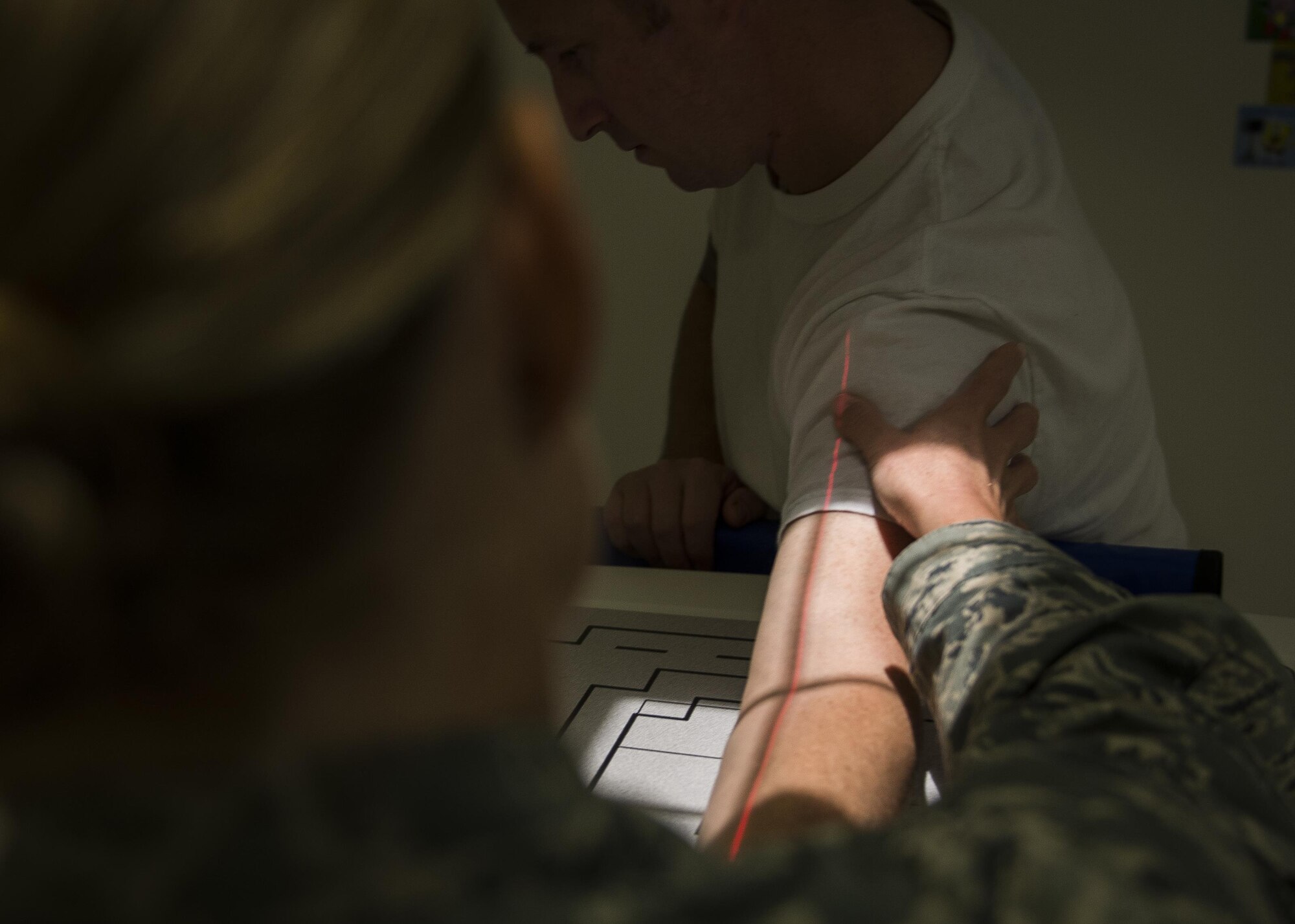 Tech. Sgt. Megan Burnett, 31st Surgical Operations Squadron diagnostic imaging flight chief, positions a patient’s arm prior to an X-ray Aug. 15, 2016, at Aviano Air Base, Italy. These medical images are used by physicians to better diagnose injury, prepare for surgery and asses how well a patient is healing. (U.S. Air Force photo by Airmen 1st Class Cory W. Bush/Released)