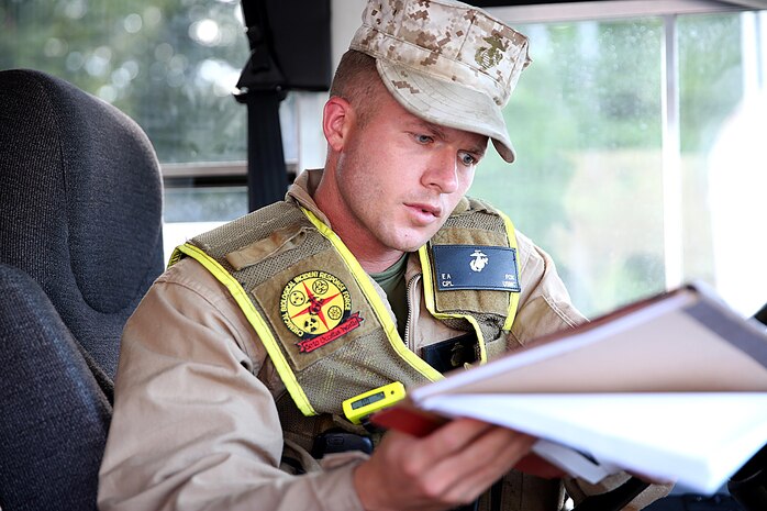 Cpl. Eric A. Fox a rifleman with the reaction platoon and bus driver for Initial Response Force B, or IRF B, with Chemical Biological Incident Response Force, CBIRF, reviews the given route book during a deployment drill in preparation for the Republican National Convention, RNC, in Cleveland, July 17, 2016.
 CBIRF’s Marines and sailors worked alongside federal and local agencies to provide chemical, biological, radiological, nuclear and high-yield explosives, CBRNE, response capability for the Republican and Democratic National Conventions.
CBIRF is an active duty Marine Corps unit that, when directed, forward-deploys and/or responds with minimal warning to a chemical, biological, radiological, nuclear or high-yield explosive (CBRNE) threat or event in order to assist local, state, or federal agencies and the geographic combatant commanders in the conduct of CBRNE response or consequence management operations, providing capabilities for command and control; agent detection and identification; search, rescue, and decontamination; and emergency medical care for contaminated personnel.  (Official USMC Photo by Lance Cpl. Maverick S. Mejia/RELEASED)