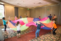 Children play with a parachute during a family retreat at Keystone, Colorado, Saturday, Aug. 13, 2016. The 50th Space Wing Chapel Office sponsored the event and provided child care during resiliency sessions so parents could focus all their attention on the session. (Courtesy photo)