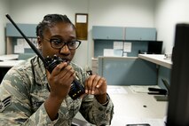 U.S. Air Force Reserve Senior Airman Arnetta Porter, an information controller assigned to the 96th Aerial Port Squadron, performs a radio check in the Air Terminal Control Center (ATOC) before coordinating a six passenger outbound mission from Little Rock Air Force Base, Ark., Aug. 14, 2016. ATOC Airmen manage the flow of information between Aerial Port work centers to coordinate aircraft flightline operations. (U.S. Air Force photo by Master Sgt. Jeff Walston) 