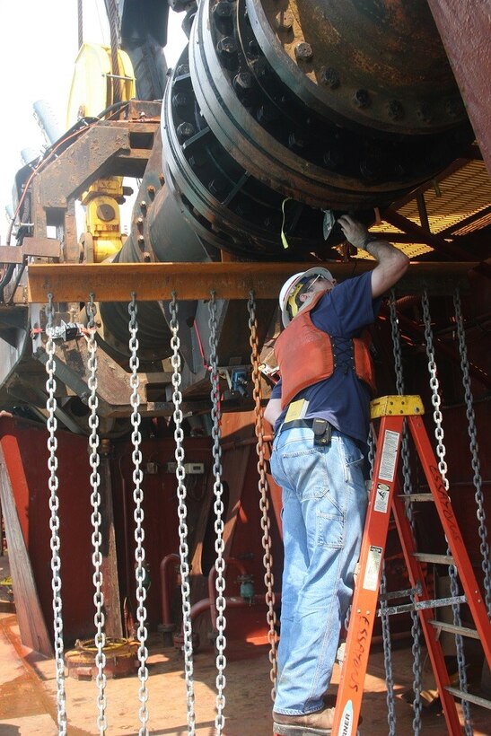 ERDC Research Hydraulic Engineer Tim Welp checks the movement of "tickler chains" designed to move sea turtles out of the way of dredging activities. The chains form a curtain extending off the dredging drag arm approximately 25 feet ahead of the draghead.

