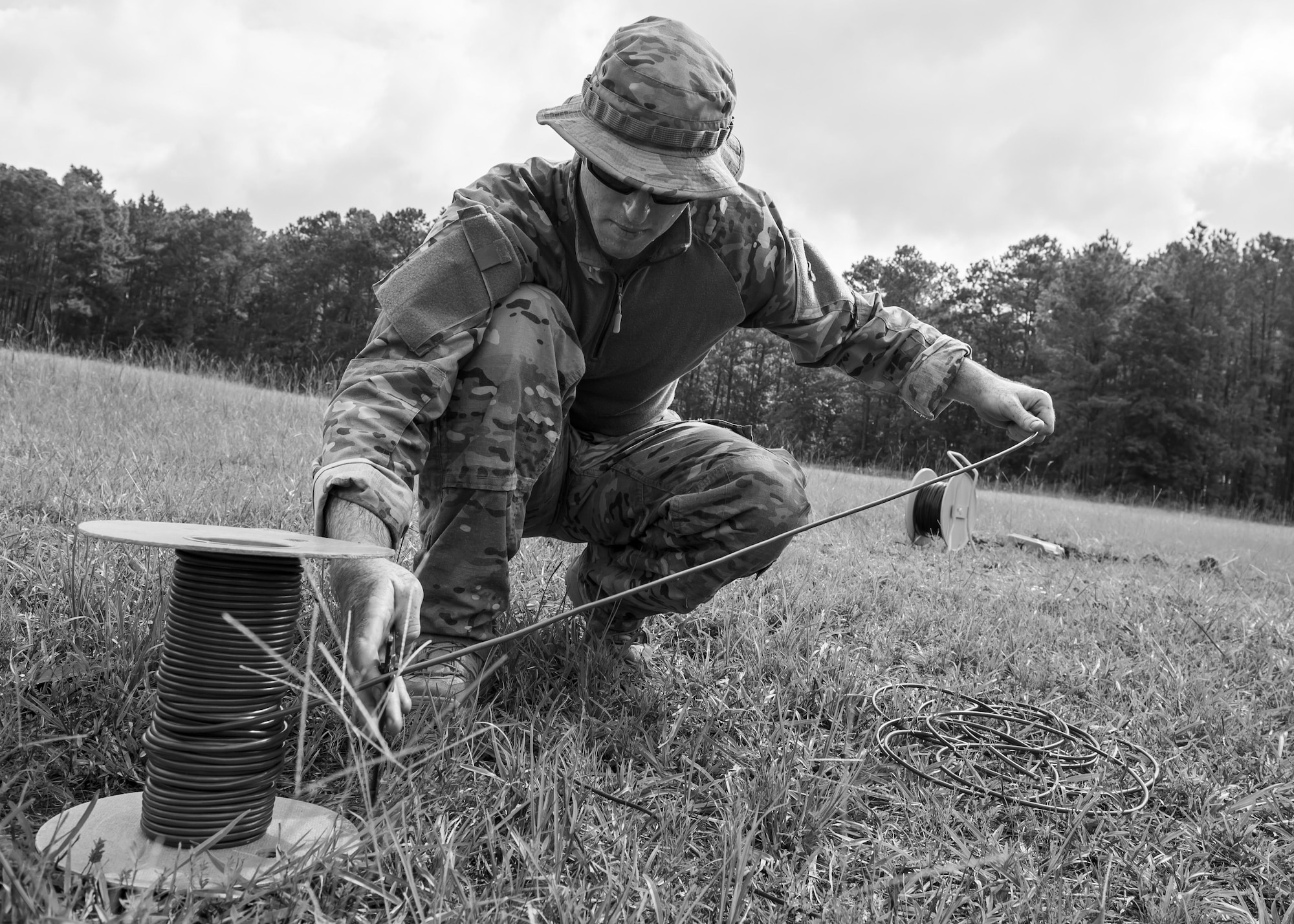 Tech. Sgt. Brenden McCavey, 315th Civil Engineering flight Explosive Ordnance Disposal technician, cuts a detonation cord, Aug. 3, 2016 at Joint Base Charleston – Weapons Station, S.C. The joint post-blast analysis training exercise included 22 participants from the Kentucky Air National Guard, South Carolina Air National Guard, Army South Carolina Guard, MacDill Air Force Base, Fla. Seymour Johnson Air Force Base, N.C., 628th Civil Engineering Squadron and 315th CEF. The trainees honed their skills of collecting evidence after an IED attack. (U.S. Air Force photo/Staff Sgt. Jared Trimarchi)