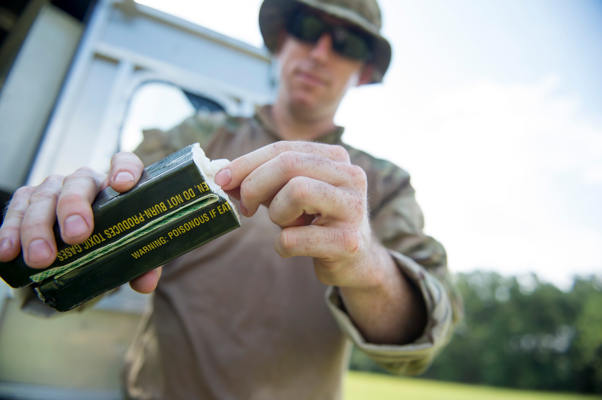 Tech. Sgt. Brenden MCavey, 315th Civil Engineering flight Explosive Ordnance Disposal technician, shows the inside of a stick of C-4 explosive, Aug. 3, 2016 at Joint Base Charleston – Weapons Station, S.C. The joint post-blast analysis training exercise included 22 participants from the Kentucky Air National Guard, South Carolina Air National Guard, Army South Carolina Guard, Mac Dill Air Force Base, Fla. Seymour Johnson Air Force Base, N.C., 628th Civil Engineering Squadron and 315th CEF. The trainees honed their skills of collecting evidence after an IED attack. (U.S. Air Force photo/Staff Sgt. Jared Trimarchi) 