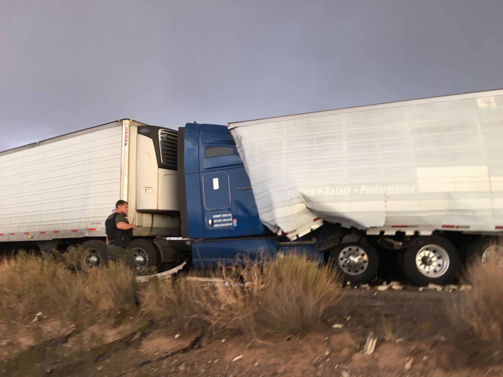 Two semitractor-trailers sit on the roadside after a sandstorm on Interstate 8 in Arizona, July 19, 2016. U.S. Air Force Staff Sgt. Eric Fullmer, 563rd Operations Support Squadron loadmaster, and Senior Airman Shane Hardin, 563rd OSS aerial delivery journeyman, assisted motorists injured in a pile up created by the sandstorm. (Courtesy photo)