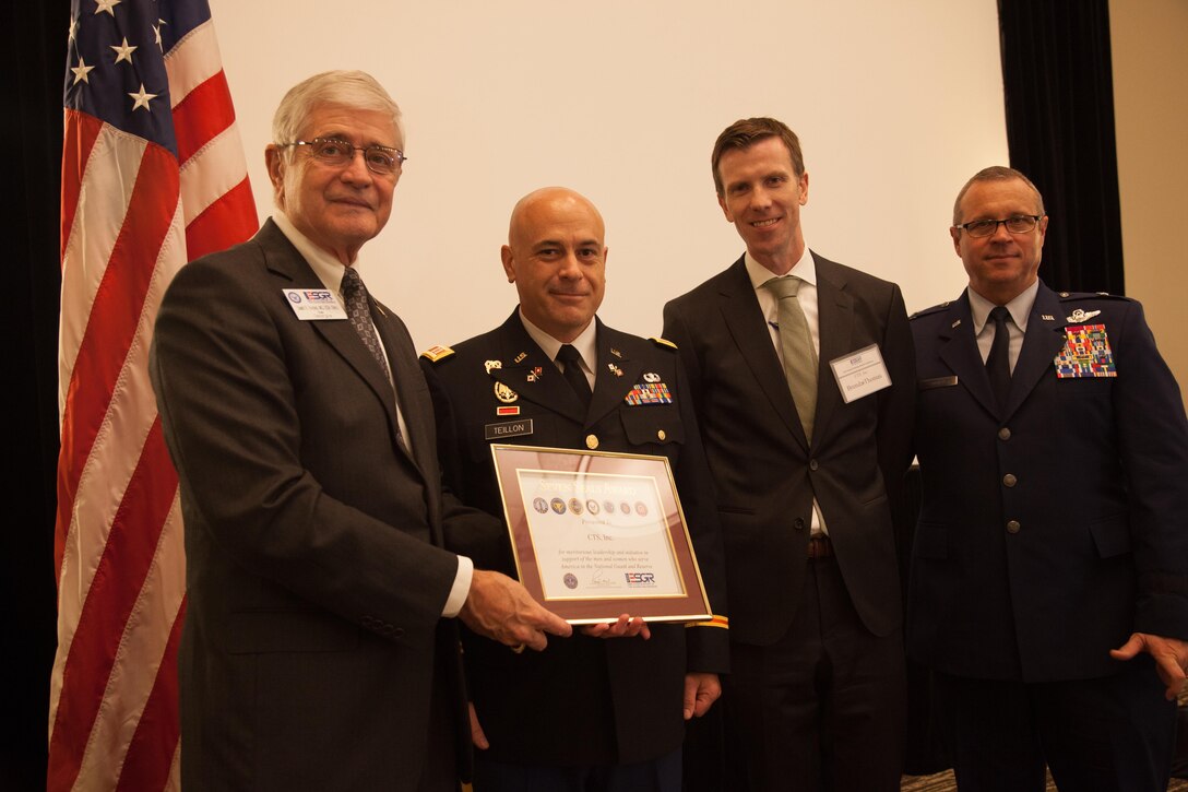 U.S. Army Reserve Capt. Spencer Teillon (Middle, Left), a Soldier assigned to 982nd Combat Camera Company (Airborne), 335th Signal Command (Theater), and Architect of Computer Technology Solutions (CTS) Incorporation, and Brendan Thomas (Middle, Right), President of CTS Inc., is awarded for contributions their software company, CTS, made to the Army Reserve and National guard at the Wyndham Hotel in Peachtree City, Georgia, Aug. 12, 2016. ESGR is a Department of Defense volunteer organization established in 1972 to promote cooperation and understanding between Reserve component members and their civilian employers and to assist in the resolution of conflicts arising from an employee's military commitment. (U.S. Army Reserve photo by Pfc. Torrance Saunders/Released)