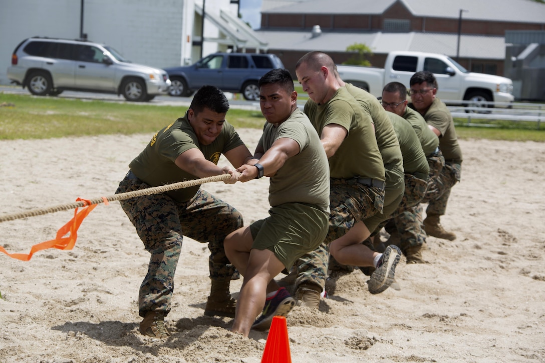 Marines participate in a tug-of-war during the 75th anniversary field meet competition at Marine Corps Air Station Cherry Point, N.C., Aug. 12, 2016. Headquarters and Headquarters Squadron, Marine Corps Air Station Cherry Point, and Marine Wing Headquarters Squadron 2, 2nd Marine Aircraft Wing, Marines of all ranks and ages came together to compete in numerous events testing their strength, teamwork and unit spirit. Some of the events the competitors participated in include: an all ranks relay, rifle relay race, unit soccer, a 7-ton pull and more. (U.S. Marine Corps photo by Cpl. N.W. Huertas/Released)