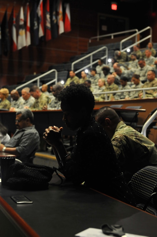 Lakeesha Blackshire prays during a memorial ceremony for Capt. Joel Ico, Aug. 14, headquarters auditorium, Mountain View, Calif. Ico died July 4 at the age of 41, following an accident at his residence. He is survived by his wife Michelle and 7 children. (U.S. Army Reserve photo by Capt. Alun Thomas)