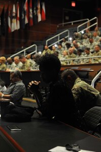 Lakeesha Blackshire prays during a memorial ceremony for Capt. Joel Ico, Aug. 14, headquarters auditorium, Mountain View, Calif. Ico died July 4 at the age of 41, following an accident at his residence. He is survived by his wife Michelle and 7 children. (U.S. Army Reserve photo by Capt. Alun Thomas)