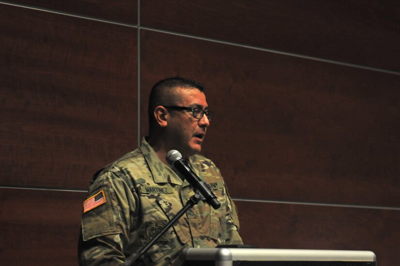 Staff Sgt. Juan Martinez, senior human resource specialist, 63rd Regional Support Command, pays tribute to Capt. Joel Ico during a memorial service for Ico, Aug. 14, headquarters auditorium, Mountain View, Calif. Ico died July 4 at the age of 41, following an accident at his residence. He is survived by his wife Michelle and 7 children. (U.S. Army Reserve photo by Capt. Alun Thomas)
