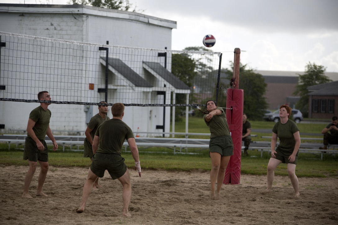 Marines Participate in a volleyball match during the 75th anniversary field meet competition at Marine Corps Air Station Cherry Point, N.C., Aug. 12, 2016. Headquarters and Headquarters Squadron, Marine Corps Air Station Cherry Point, and Marine Wing Headquarters Squadron 2, 2nd Marine Aircraft Wing, Marines of all ranks and ages came together to compete in numerous events testing their strength, teamwork and unit spirit. Some of the events the competitors participated in include: an all ranks relay, rifle relay race, unit soccer, a 7-ton pull and more. (U.S. Marine Corps photo by Cpl. N.W. Huertas/Released)