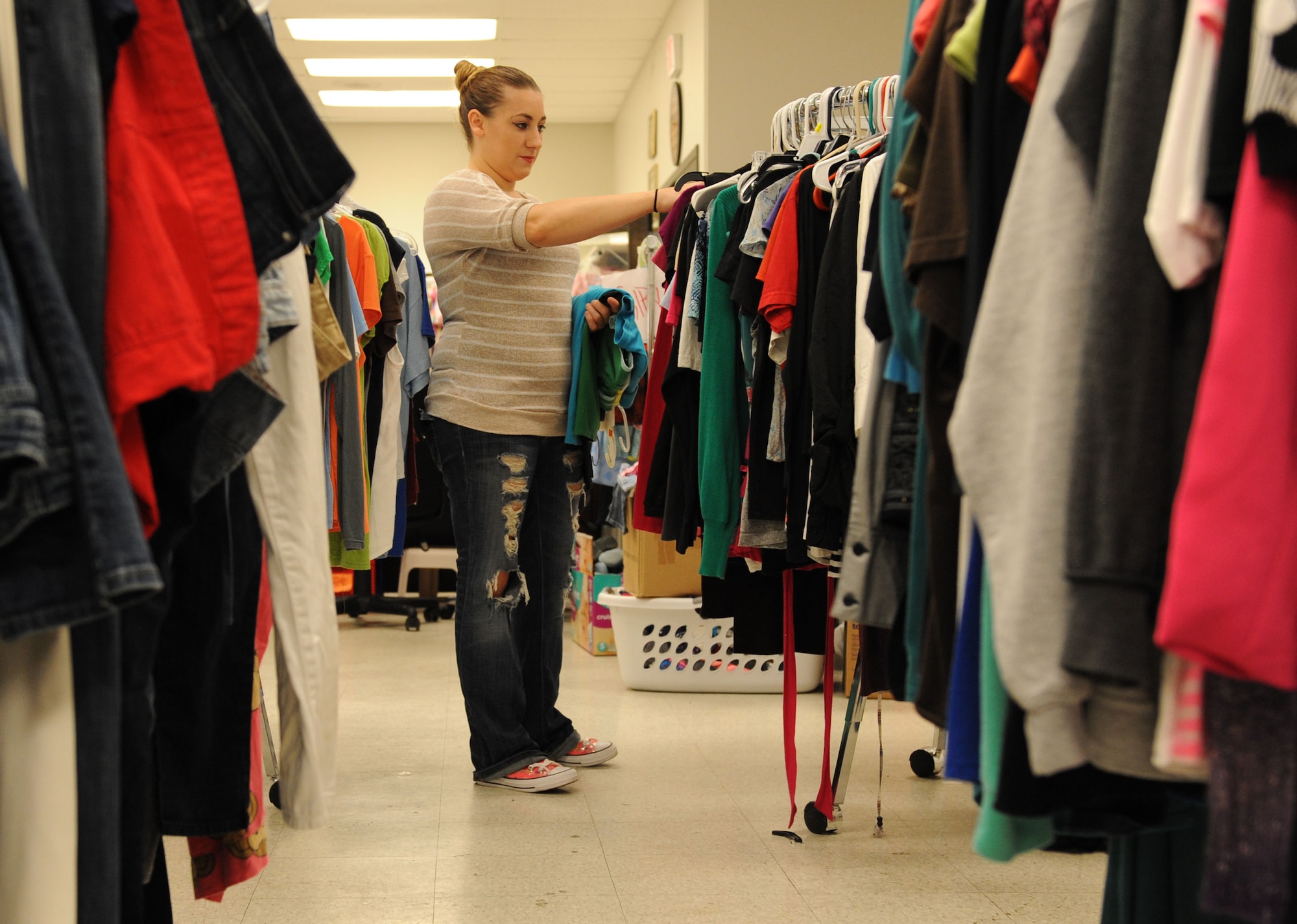 Brittany Alton, spouse of U.S. Marine Corps Sgt. Stephen Alton, Keesler Marine Detachment instructor, sorts through clothing items at the Airman’s Attic Aug. 12, 2016, on Keesler Air Force Base, Miss. The Airman’s Attic assists enlisted members in pay grades E-1 through E-6 with obtaining basic household items at no cost. It is located at the corner of Meadows Drive and 1st Street, next to the Keesler Thrift Shop. (U.S. Air Force photo by Kemberly Groue/Released)