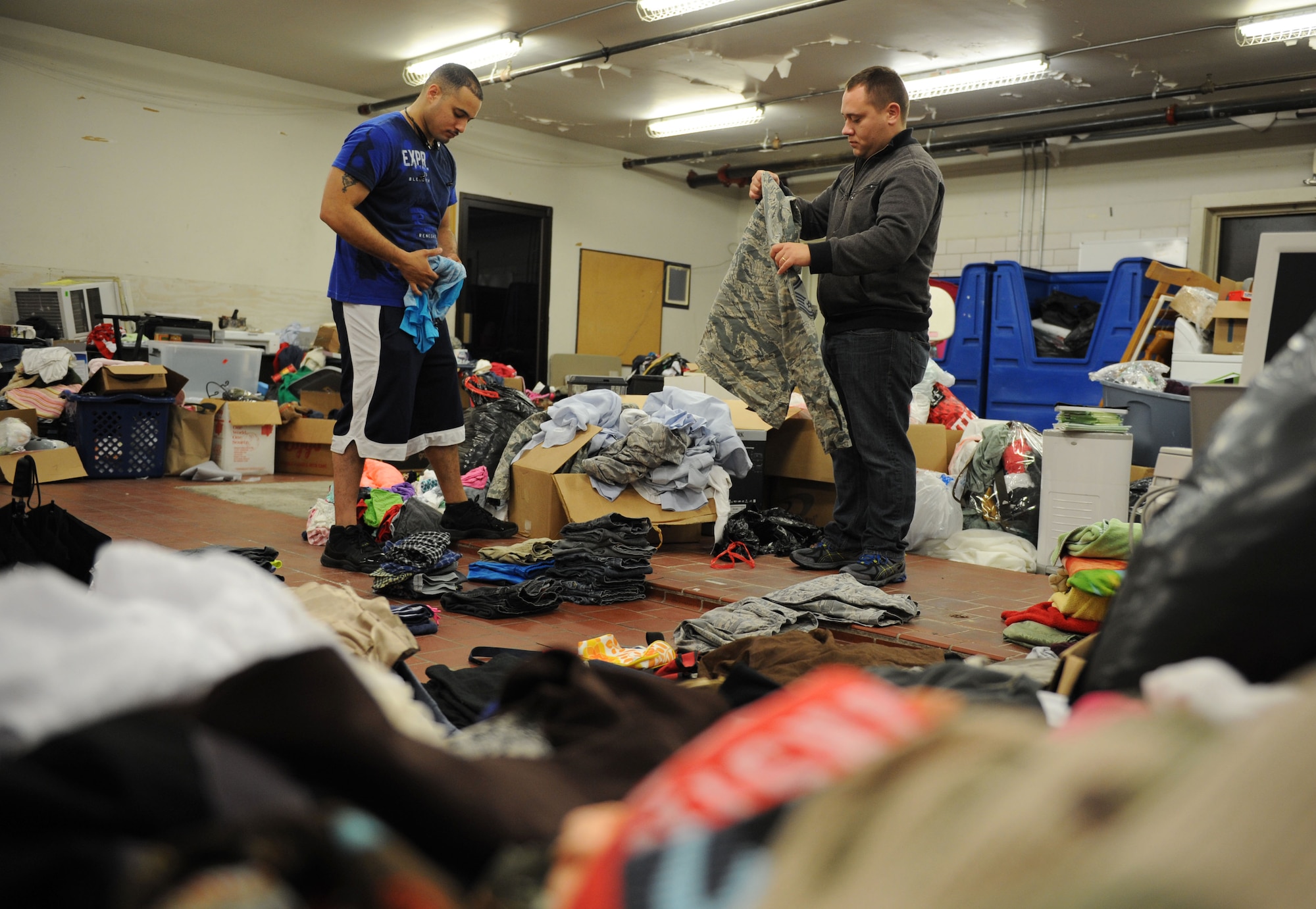 Tech. Sgts. Alex De Fex, 336th Training Squadron student, and William Thompson, 335th TRS student, sort and fold clothing items at the Airman’s Attic Aug. 12, 2016, on Keesler Air Force Base, Miss. The Airman’s Attic assists enlisted members in pay grades E-1 through E-6 with obtaining basic household items at no cost. It is located at the corner of Meadows Drive and 1st Street, next to the Keesler Thrift Shop. (U.S. Air Force photo by Kemberly Groue/Released)