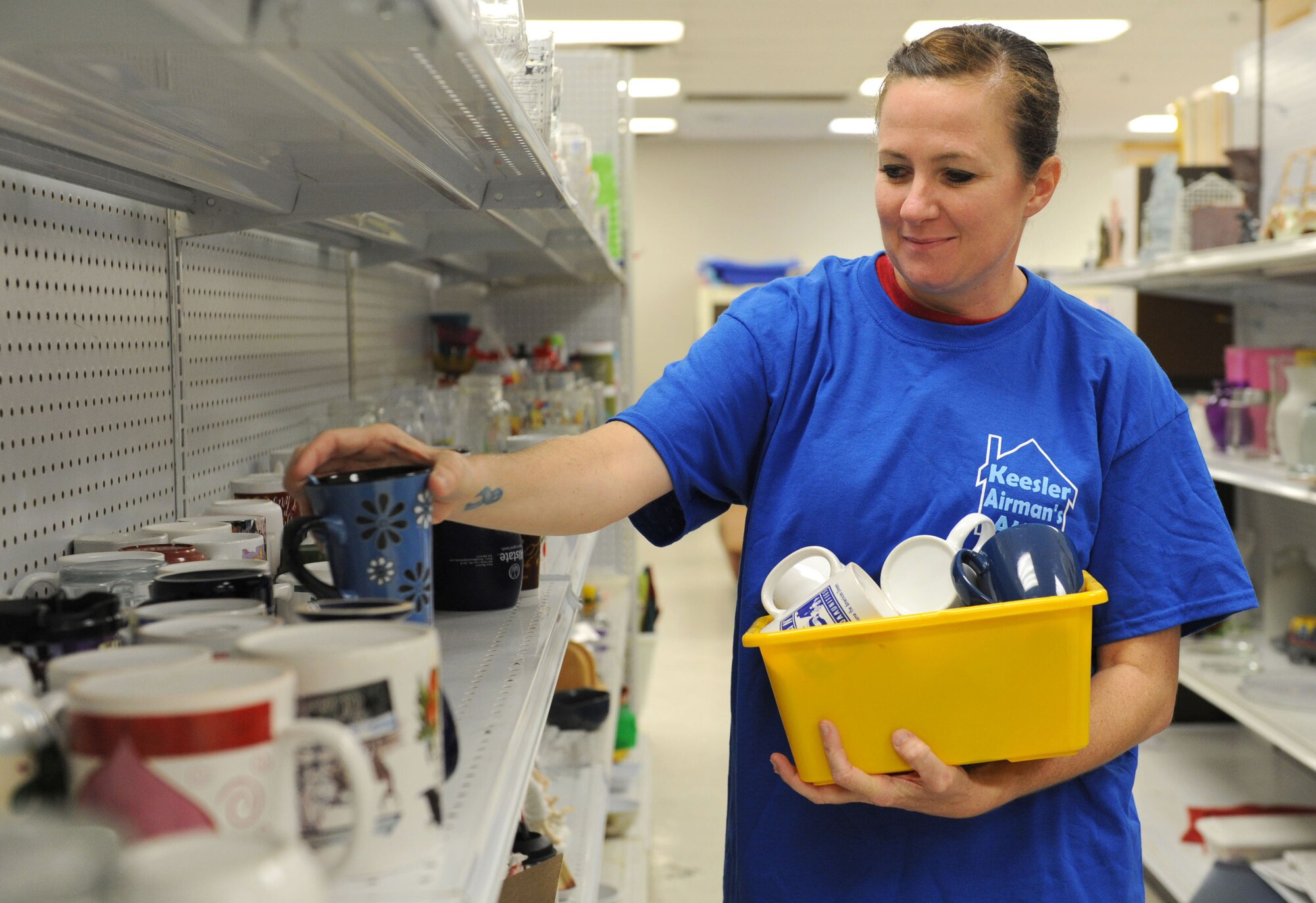 Master Sgt. Tiffany Satterwhite, 335th Training Squadron instructor and Keesler Airman’s Attic executive council president, restocks a shelf at the Airman’s Attic Aug. 12, 2016, on Keesler Air Force Base, Miss. The Airman’s Attic assists enlisted members in pay grades E-1 through E-6 with obtaining basic household items at no cost. It is located at the corner of Meadows Drive and 1st Street, next to the Keesler Thrift Shop. (U.S. Air Force photo by Kemberly Groue/Released)