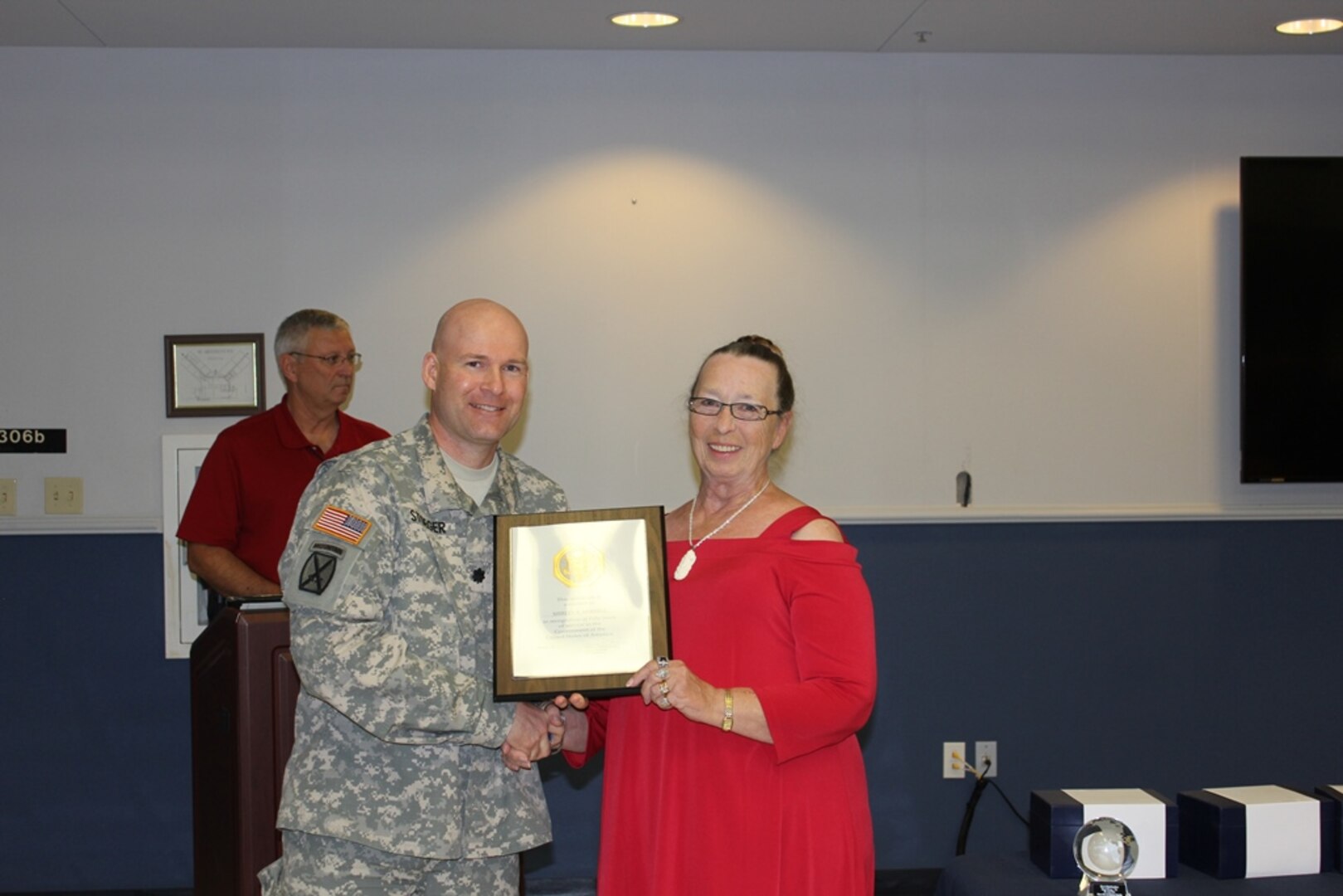 DLA Distribution Red River, Texas, commander Army Lt. Col. Anthony A. Stoeger presents Shirley A. Merrell with an award for 50 years of federal service.