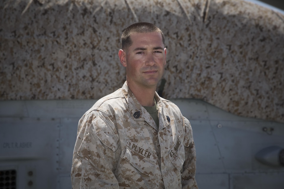 Staff Sgt. Daniel Plyler, flight equipment technician, Marine Light Attack Helicopter Squadron 169 from Marine Corps Base Camp Pendleton, Calif., stands in front of a Bell AH-1Z helicopter on the flight deck aboard Marine Corps Air Ground Combat Center, Twentynine Palms, Calif., Aug. 5, 2016. Plyler constructed canopy covers for the AH-1Z to reduce the effects of heat on the aircraft and the Marines who operate it. (Official Marine Corps photo by Cpl. Medina Ayala-Lo/Released)