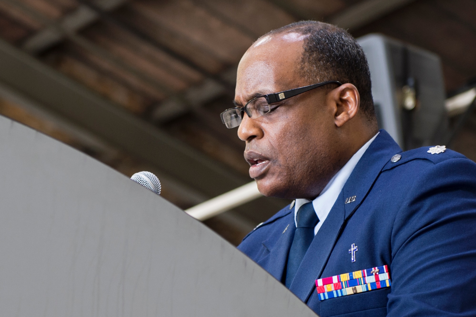 Chaplain (Lt. Col.) Obadiah Smith, Jr., 434th Air Refueling Wing chaplain, prays during a change of command ceremony at Grissom Air Reserve Base, Ind., July 9, 2016. As a religious leader of the military, Smith is responsible for tending to the religious and moral well-being of service members and their families. (U.S. Air Force photo/Tech. Sgt. Benjamin Mota)