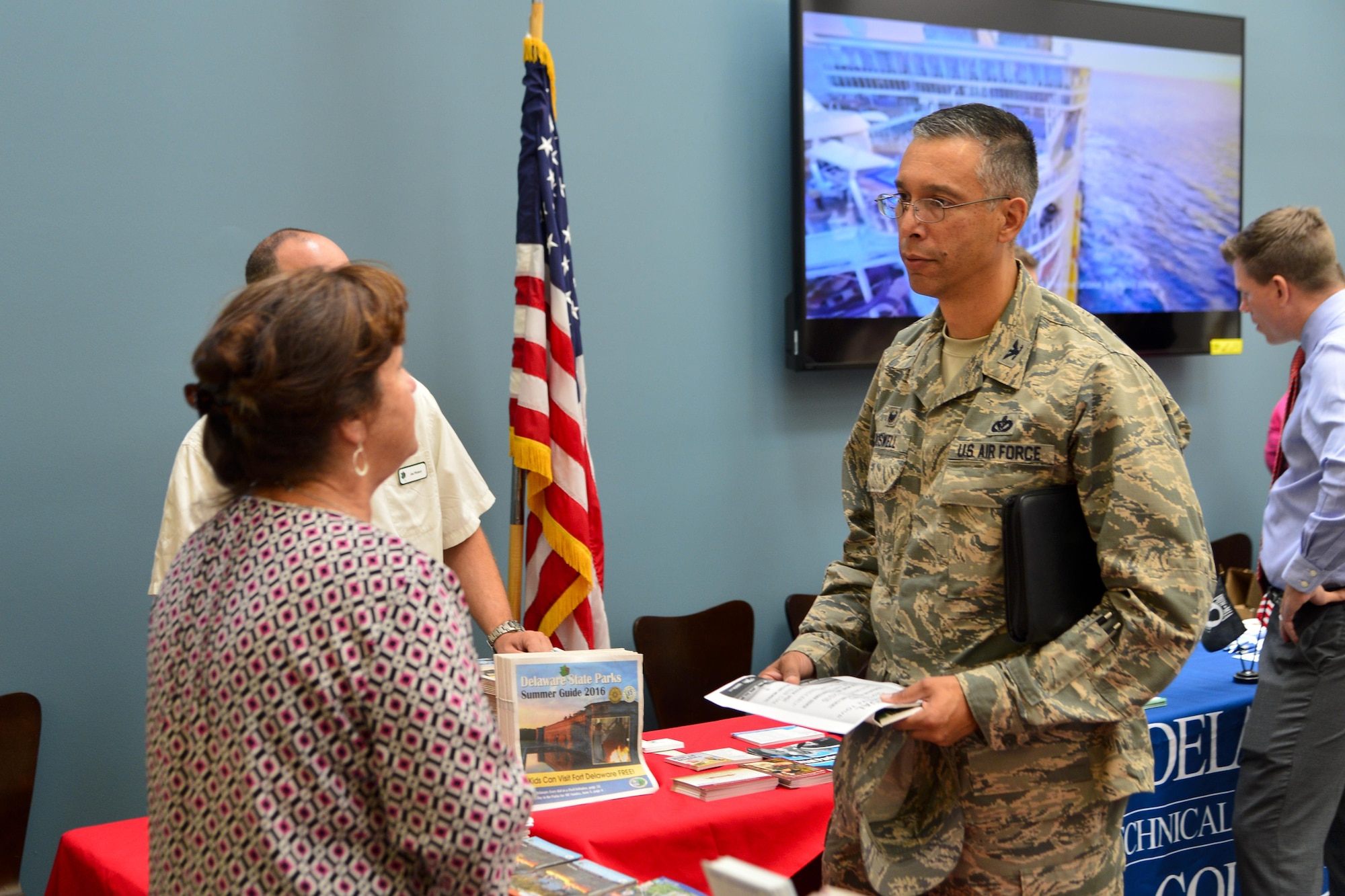 Col. Randy Boswell, 436th Mission Support Group commander, receives an informational flyer from the Delaware’s Capital Region while visiting various booths at the ‘Dover Welcomes You’ session Aug. 11, 2016, at the Patterson Dining Facility on Dover Air Force Base, Del. These sessions are sponsored by the Central Delaware Chamber of Commerce. (U.S. Air Force photo by Senior Airman William Johnson)