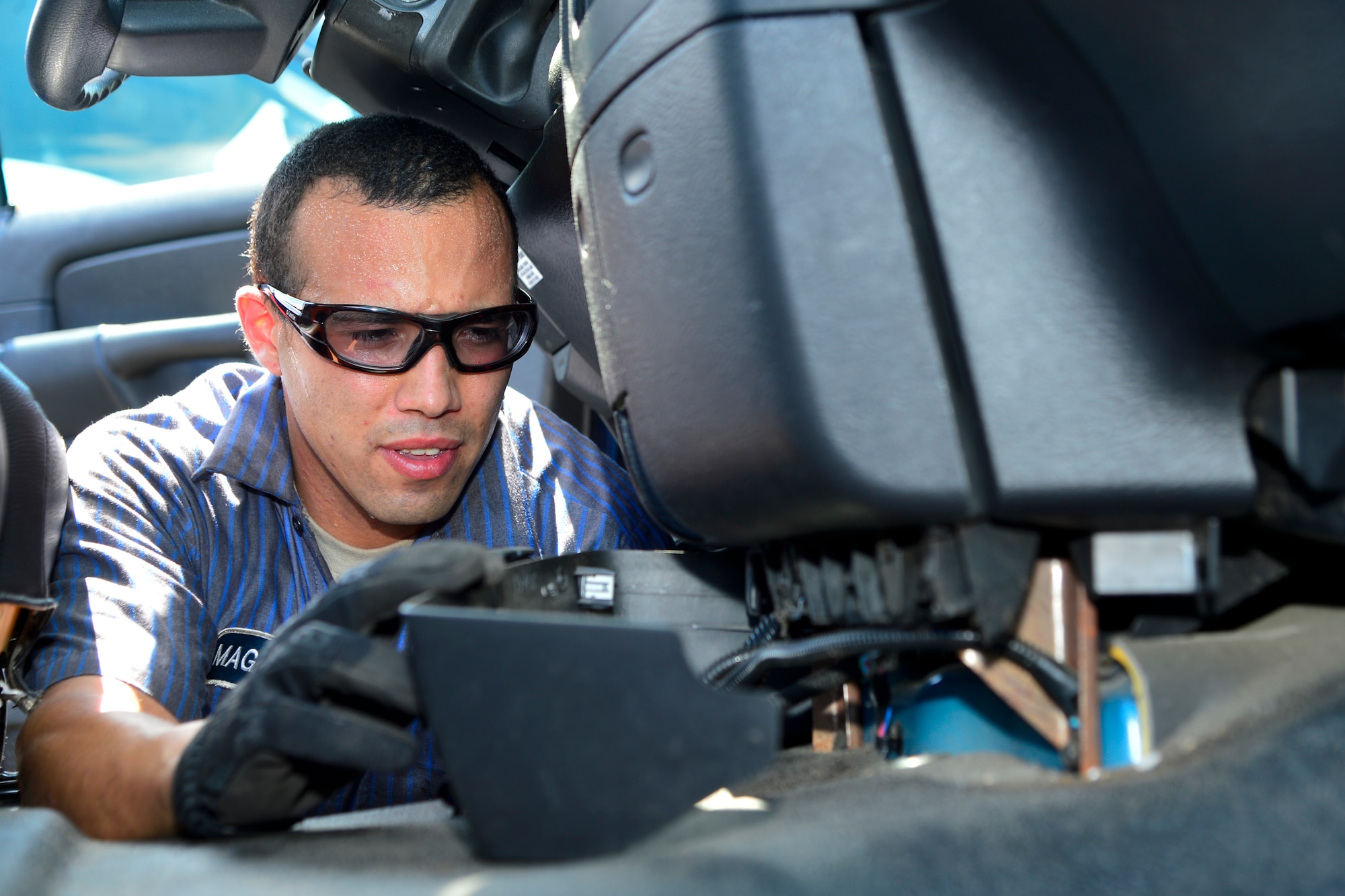 Airman 1st Class Ricardo Magana B, 436th Logistics Readiness Squadron vehicle maintenance, installs a propane control switch inside of a 436th Civil Engineer Squadron vehicle Aug. 11, 2016, at Dover Air Force Base, Del. The switch allows the operator of the vehicle to power the propane injector for the vehicle. (U.S. Air Force photo by Senior Airman William Johnson)