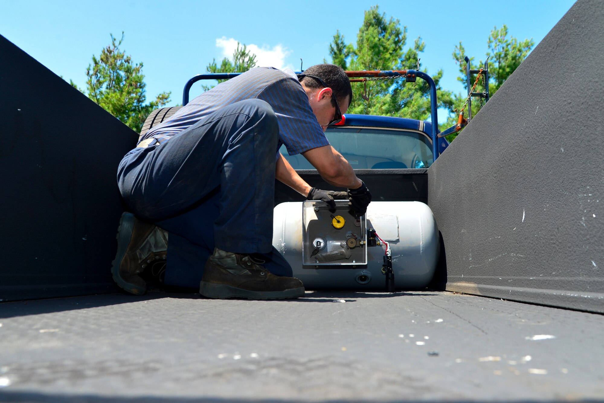Airman 1st Class Ricardo Magana B, 436th Logistics Readiness Squadron vehicle maintenance, installs a 24-gallon propane tank on a 436th Civil Engineer Squadron vehicle Aug. 11, 2016, at Dover Air Force Base, Del. Dover AFB is participating in a yearlong study to see the effects of propane on Air Force diesel vehicles. (U.S. Air Force photo by Senior Airman William Johnson)