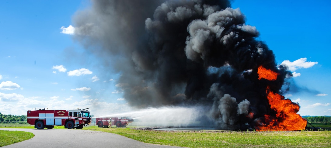 An Air Force P19 crash truck extinguishes a jet fuel fire in a burn pit during live-fire training as part of Exercise Patriot Warrior 2016 at Fort McCoy Airport, Wis., Aug. 8, 2016. Air Force photo by Airman 1st Class Christopher Dyer