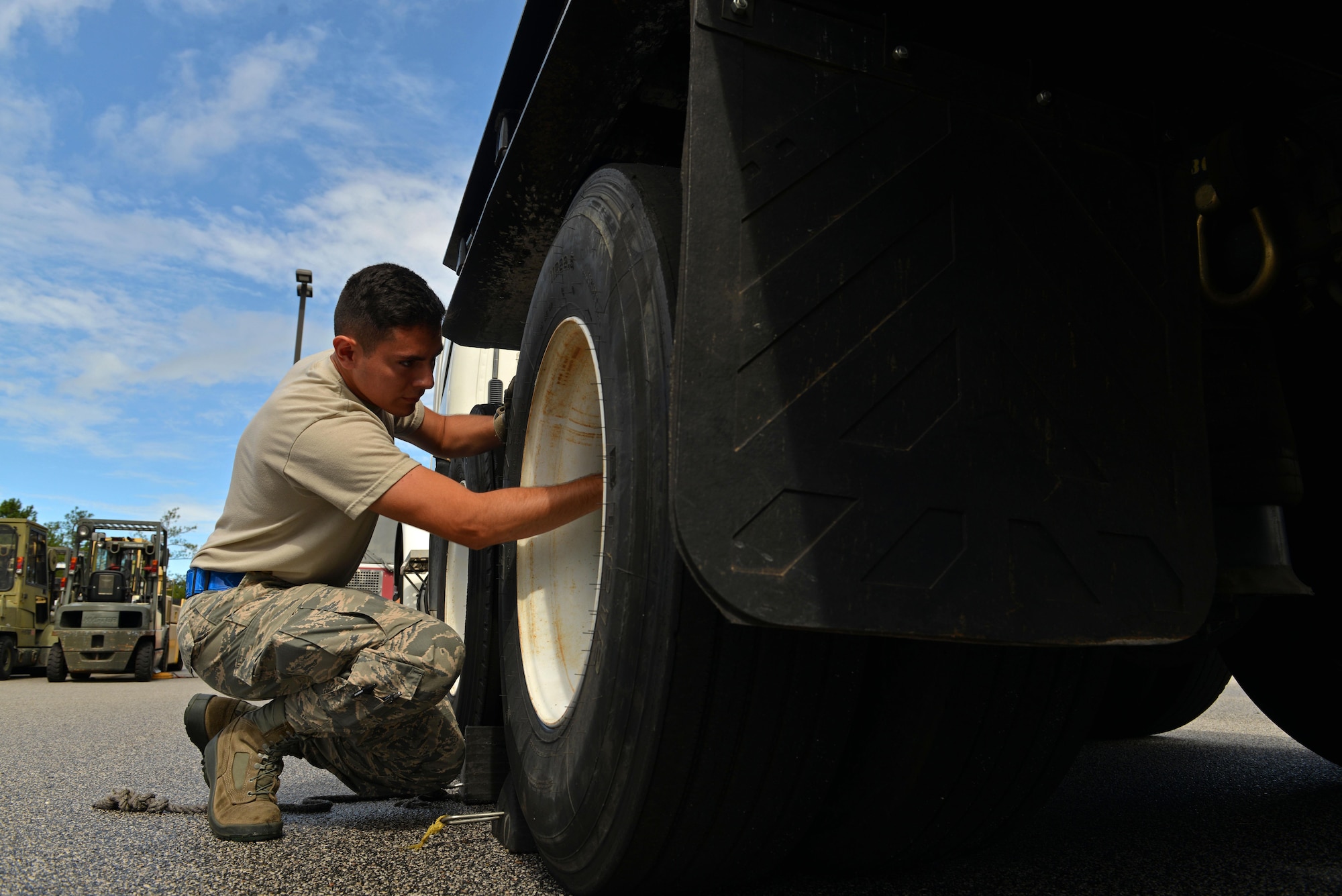 U.S. Air Force Airman Alejandro Ponce, 20th Logistics Readiness Squadron vehicle operations dispatcher, inspects the tires of a tractor trailer at Shaw Air Force Base, S.C., Aug. 10, 2016. Personnel are required to check vehicle fluids, tire pressure and mechanical functions during their weekly inspections. (U.S. Air Force photo by Airman 1st Class Destinee Sweeney)