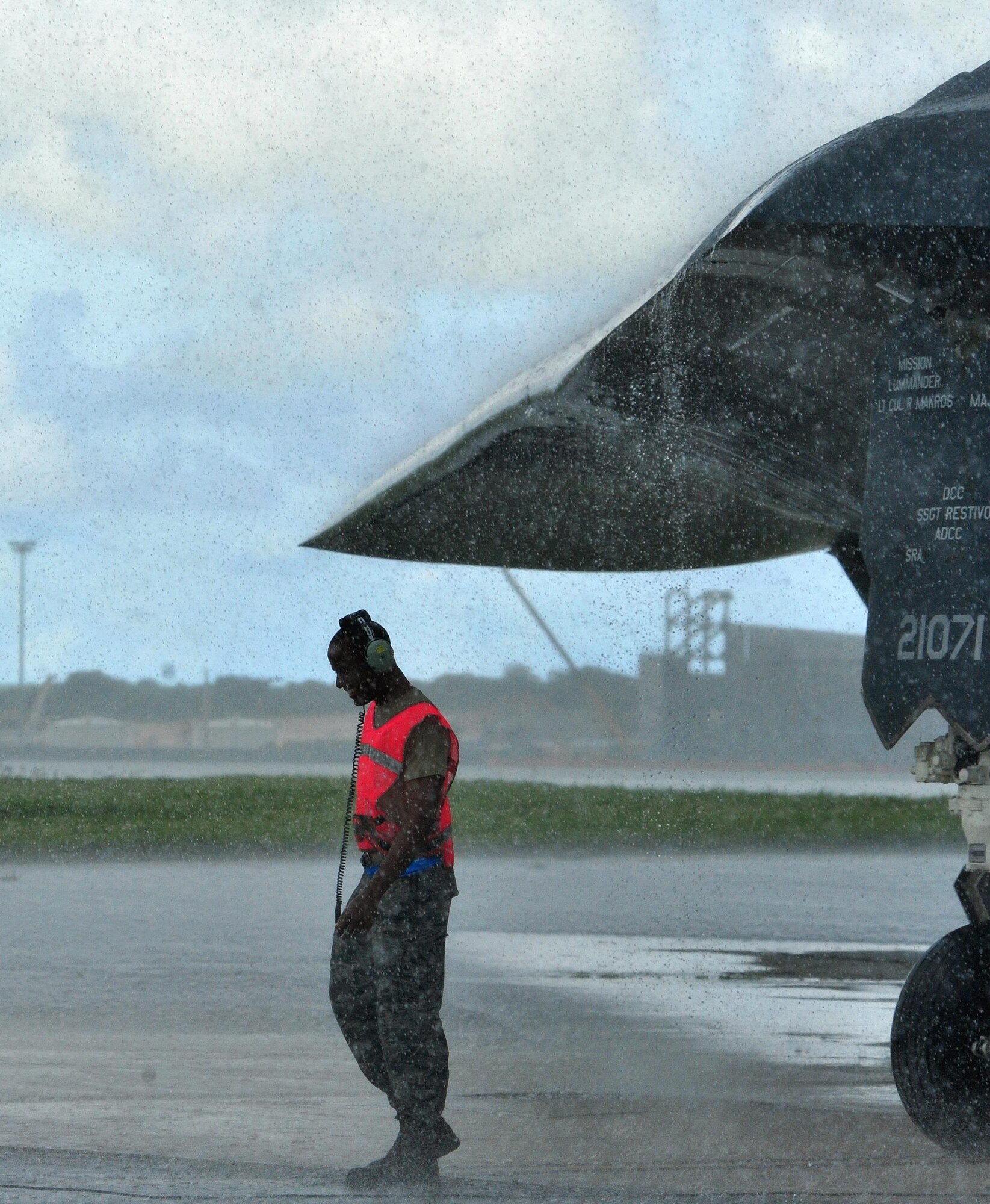 U.S. Air Force Senior Airman Khari Harris, a crew chief assigned to the 509th Aircraft Maintenance Squadron, deployed from Whiteman Air Force Base, Mo., endures rainy conditions to prepare a B-2 Spirit aircraft for take off at Andersen Air Force Base, Guam, Aug,11, 2016. Bomber operations provide a visible demonstration of the U.S. ability to project power globally and respond to any potential crisis or challenge. (U.S. Air Force photo by Senior Airman Jovan Banks)
