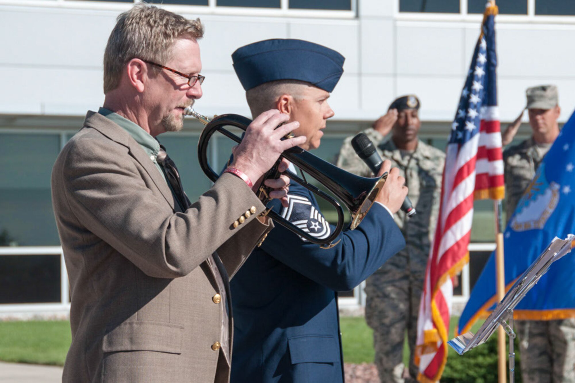 James Crosby on trumpet alongside Senior Master Sgt. Jason Gravitt perform the national anthem during the opening ceremony celebrating the 310th Mission Support Group’s movement to the Headquarters building for the 310th Space Wing on Schriever AFB, Colo., Aug. 7, 2016.