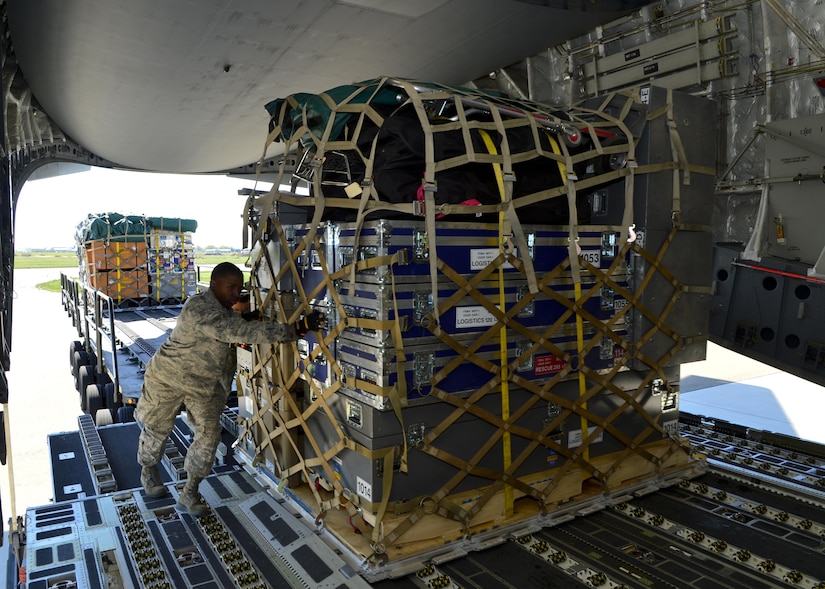Airmen from Team Dover and Joint Base McGuire-Dix-Lakehurst, N.J., load a C-17 Globemaster III from the 6th Airlift Squadron, 305th Air Mobility Wing, with approximately 70,000 pounds of humanitarian relief supplies April 26, 2015, at Dover Air Force Base, Del. Sixty-nine members and six search and rescue K-9s from the Fairfax County Urban Search and Rescue team were part of the relief efforts.