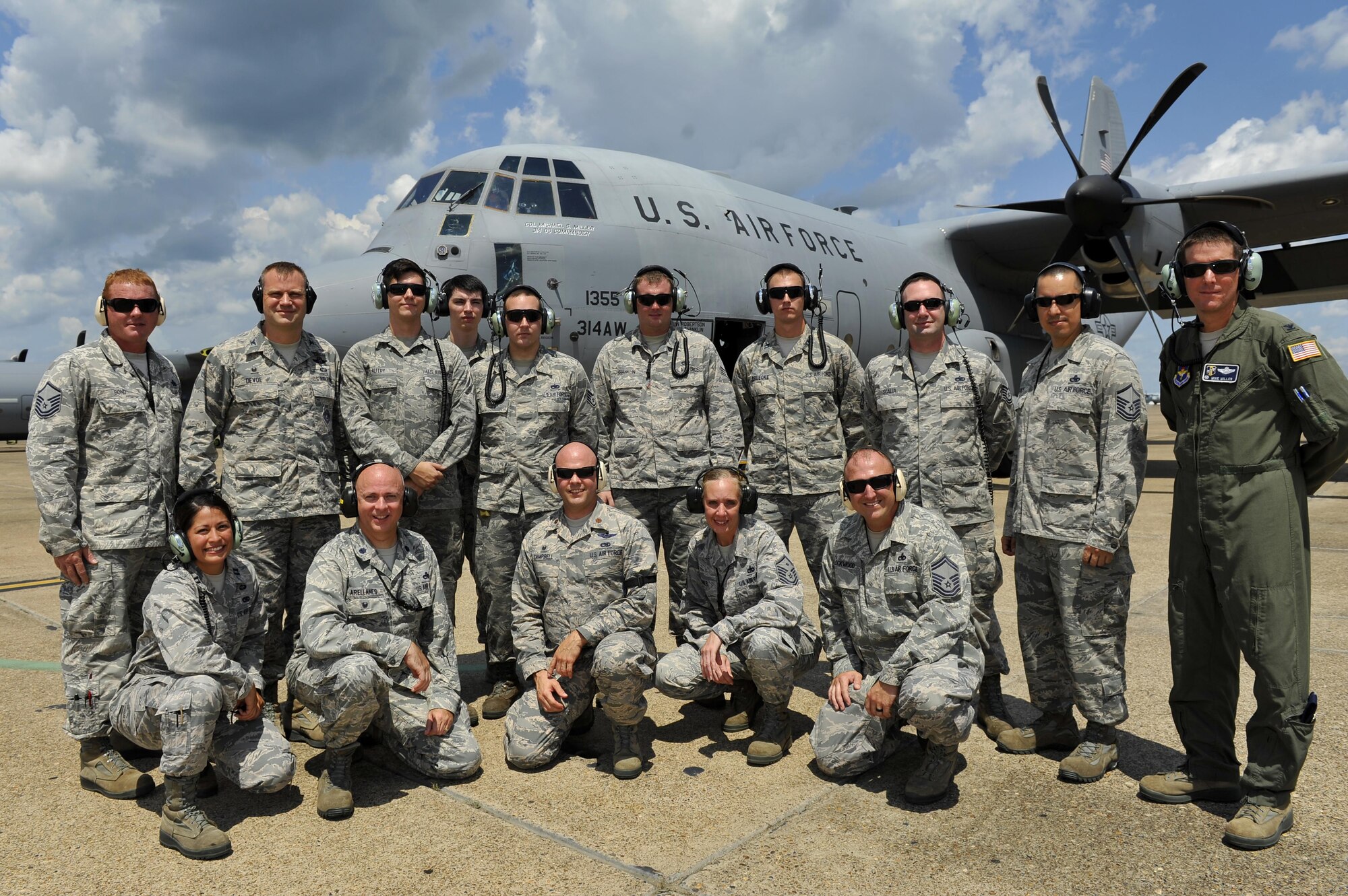 Service members assigned to the 314th Airlift Wing pose behind C-130J Tail No. 1335 Aug. 11, 2016, at Little Rock Air Force Base, Ark. The C-130J Tail No. 1335 earned the Black-Letter Initial achievement by flying with zero minor discrepancies. (U.S. Air Force photo by Kevin Sommer Giron)