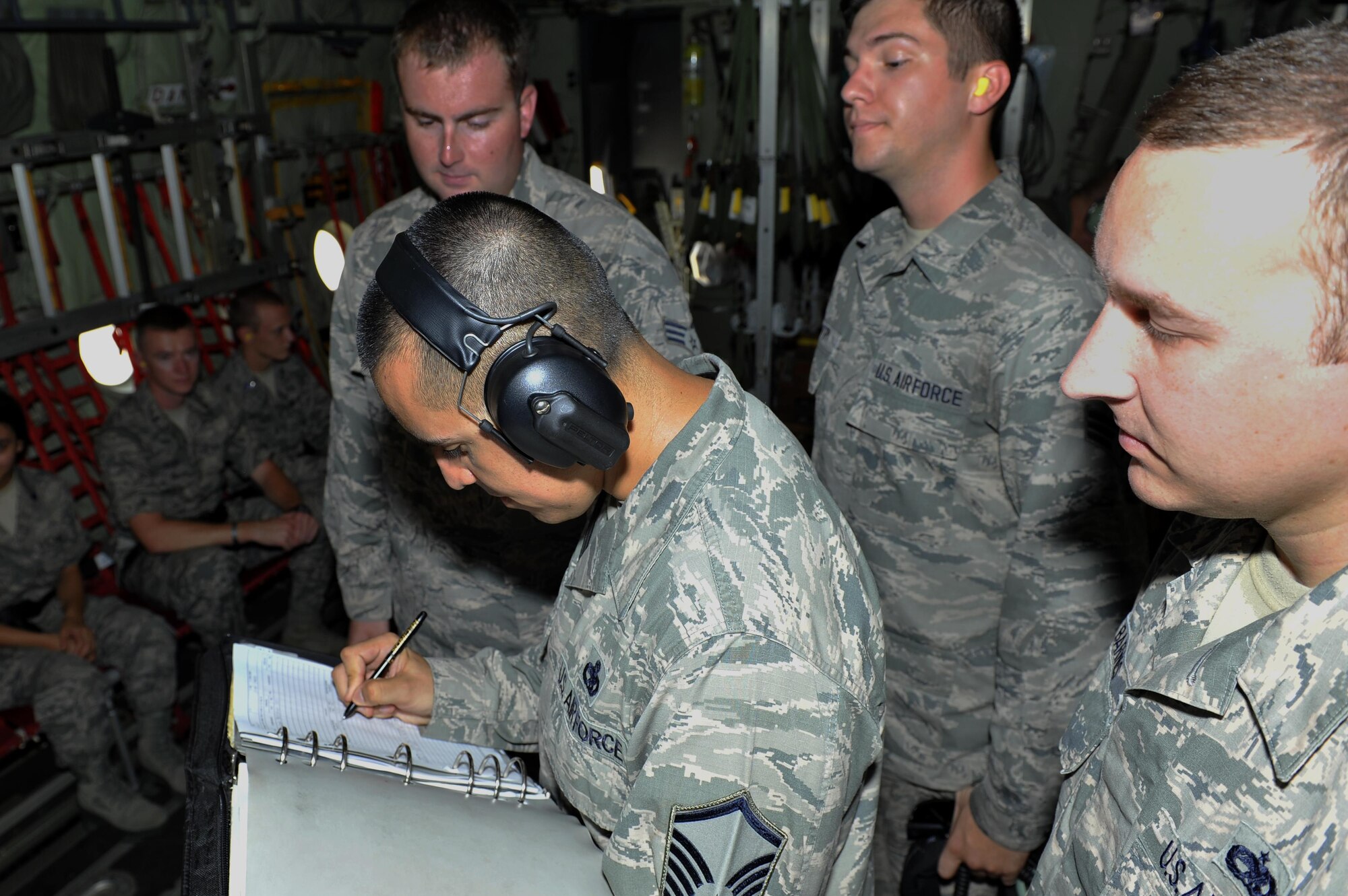 U.S. Air Force Master Sgt. John Recinos, 314th Maintenance Squadron lead production superintendent, initials the exceptional release form Aug. 11, 2016, at Little Rock Air Force base. The exceptional release form verifies there are no maintenance issues on the aircraft. (U.S. Air Force photo by Kevin Sommer Giron)