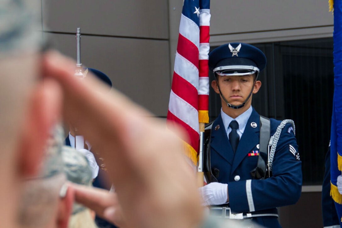 The lead member of the the High Frontier Honor Guard stands at attention as the National Anthem is played and the audience renders proper respect, during the 310th Operations Group change of Command on Schriever Air Force Base, Colorado, Sunday, Aug. 7, 2016