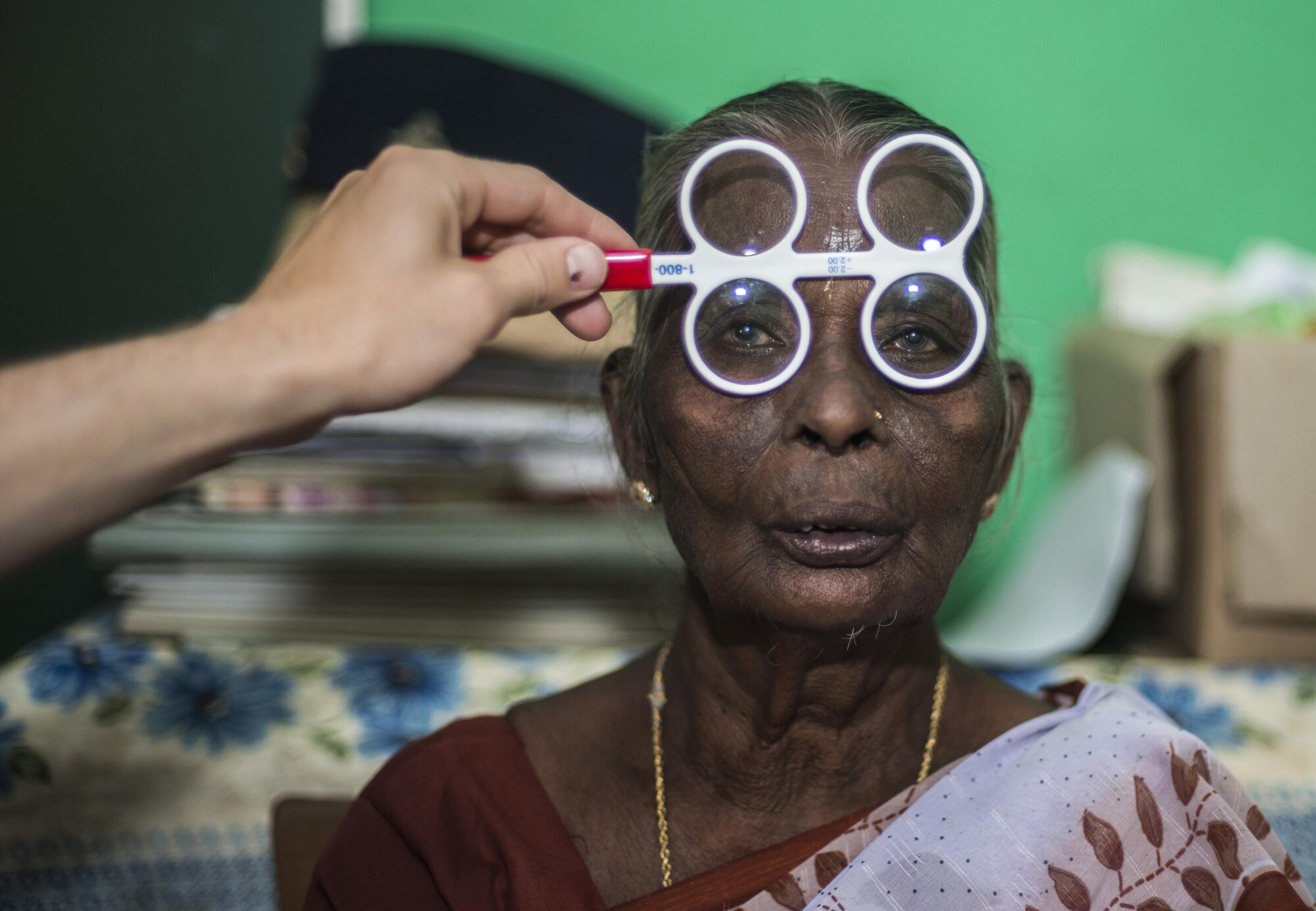 A Sri Lankan local national woman receives an eye exam during Pacific Angel (PACANGEL) 16-3 in Jaffna, Sri Lanka, Aug. 15, 2016. Assistance during PACANGEL includes general health, dental, optometry, physical therapy and engineering programs as well as various subject-matter expert exchanges.  (U.S. Air Force photo by Senior Airman Brittany A. Chase)