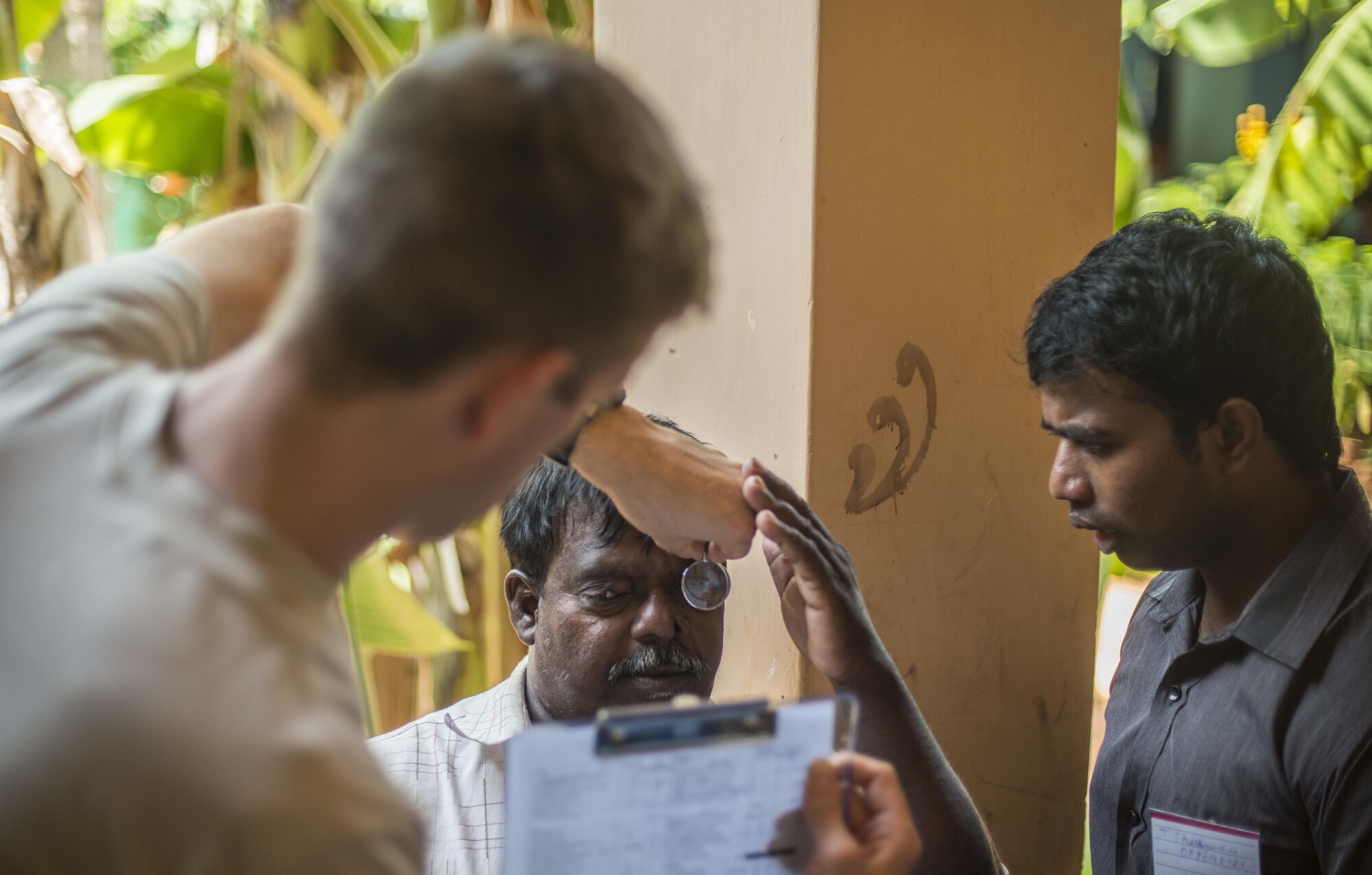 U.S. Air Force Capt. Davis Staley, 673rd Medical Group optometrist, examines a patient with severe tumors on his eyes during Pacific Angel (PACANGEL) 16-3 in Jaffna, Sri Lanka, Aug. 16, 2016. Operation PACANGEL 16 is a joint and combined humanitarian assistance operation. Led by Pacific Air Forces, the exercise enhances participating nations’ humanitarian assistance and disaster relief (HA/DR) capabilities while providing needed services to people in need throughout Southeast Asia. (U.S. Air Force photo by Senior Airman Brittany A. Chase)