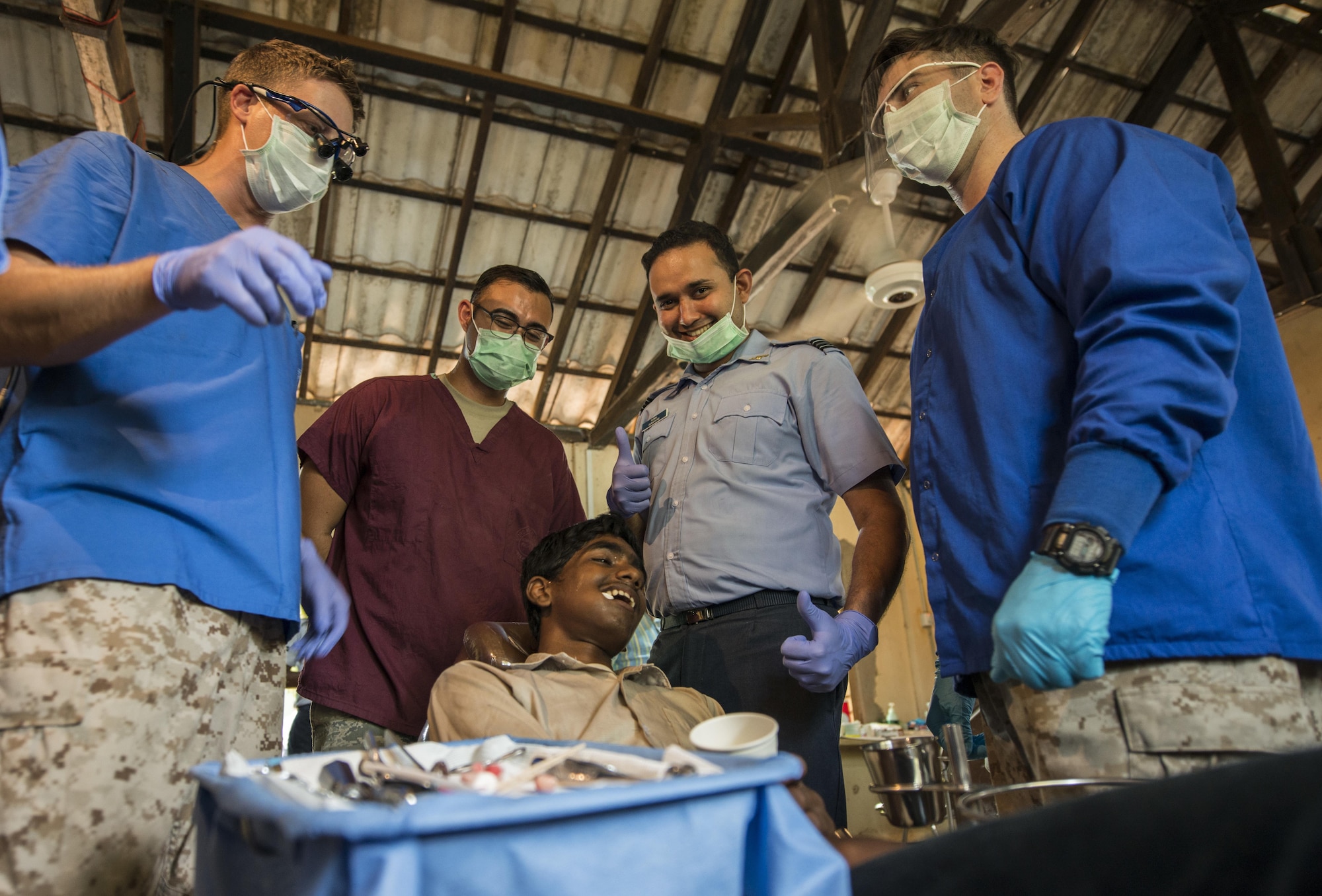 Members from the U.S. Navy, U.S. Air Force and Sri Lankan Air Force smile after a tooth extraction during Pacific Angel (PACANGEL) 16-3 in Jaffna, Sri Lanka, Aug. 16, 2016. Operation PACANGEL 16 is a joint and combined humanitarian assistance operation. Led by Pacific Air Forces, the exercise enhances participating nations’ humanitarian assistance and disaster relief (HA/DR) capabilities while providing needed services to people in need throughout Southeast Asia. (U.S. Air Force photo by Senior Airman Brittany A. Chase)