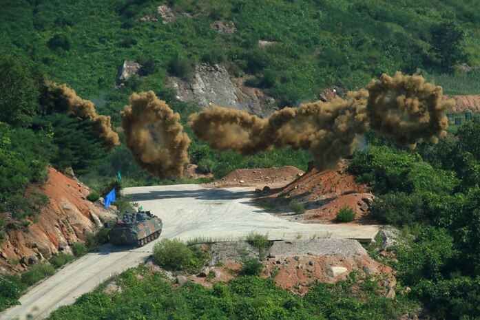 Smoke rings launched by a South Korean army K200 Infantry Fighting Vehicle burst over a training ground where earlier this month South Korean and U.S. troops practiced working as a single force to assault an objective with ground troops supported by aircraft. The smoke helps hinder the enemy’s view. The training ran July 30 through Aug. 4 at a training range near Pocheon and involved U.S. troops from Company B, 2nd Battalion, 12th Cavalry Regiment, part of the 1st Cavalry Division’s 1st Armored Brigade Combat Team. The brigade is on a nine-month rotational tour with the 2nd Infantry Division/ROK-U.S. Combined Division. Their Korean counterparts were from the 137th Mechanized Battalion, 16th Mechanized Brigade, 8th Infantry Division.  